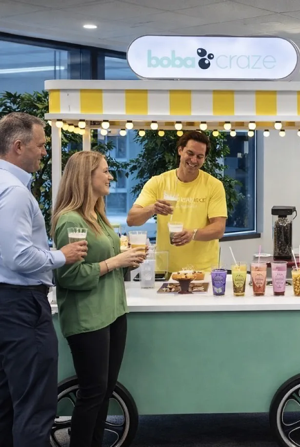 Guests being served Boba Craze drinks from the mobile cart at a corporate event