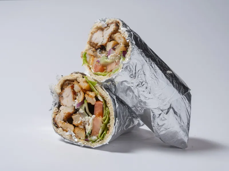 A chicken mega pita cut in half and wrapped in foil