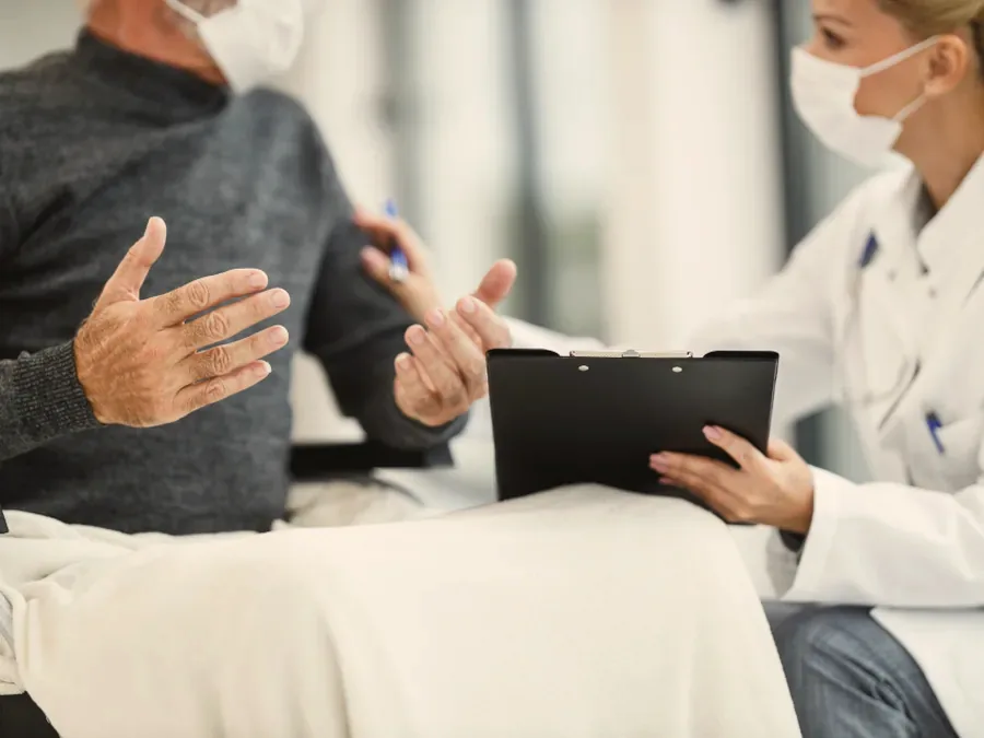 A clinician discussing symptoms with a patient