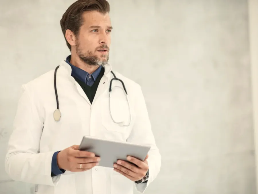 A physician with a tablet in the clinic