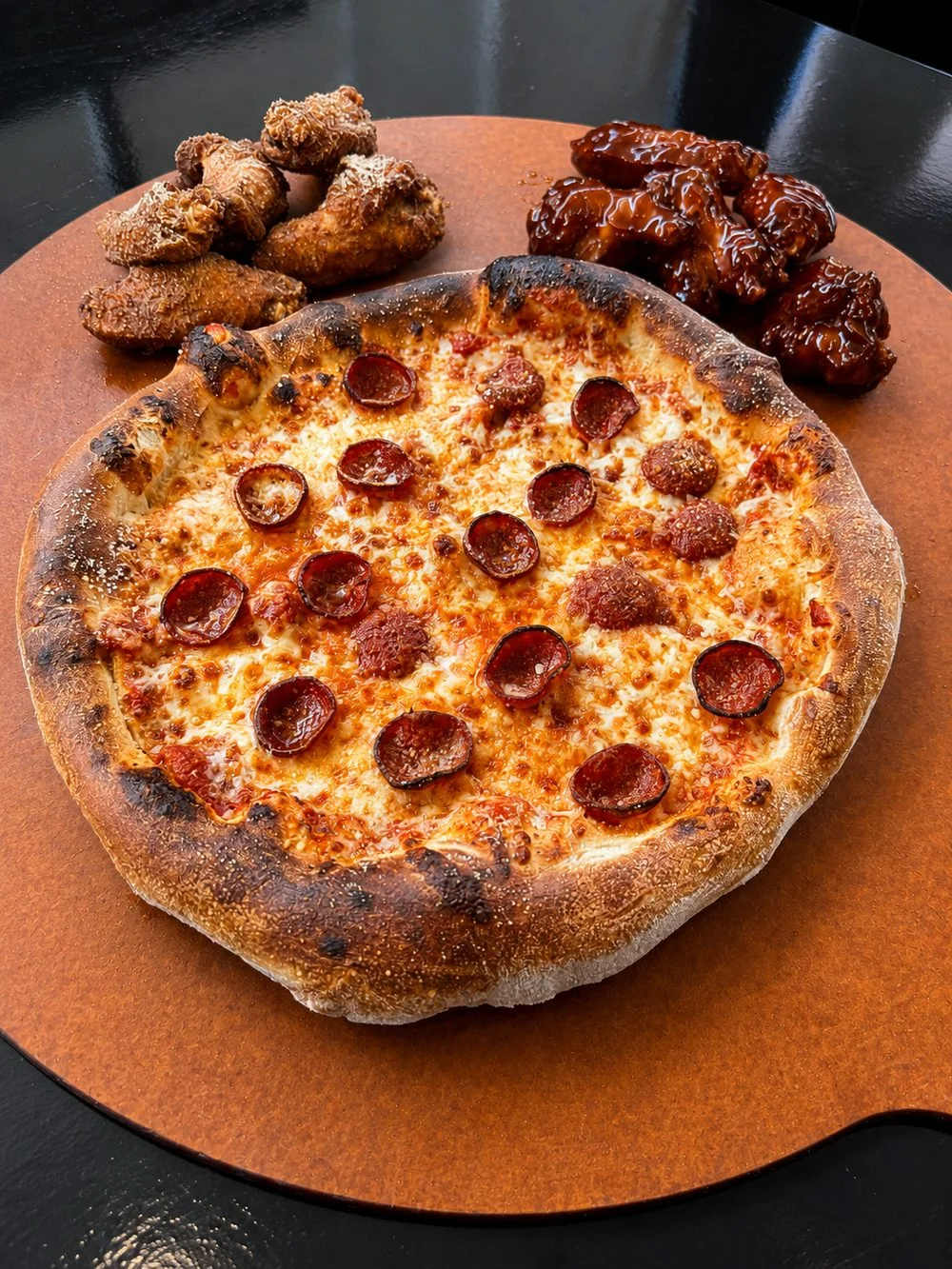 Fire King Pizza pepperoni pie with wings