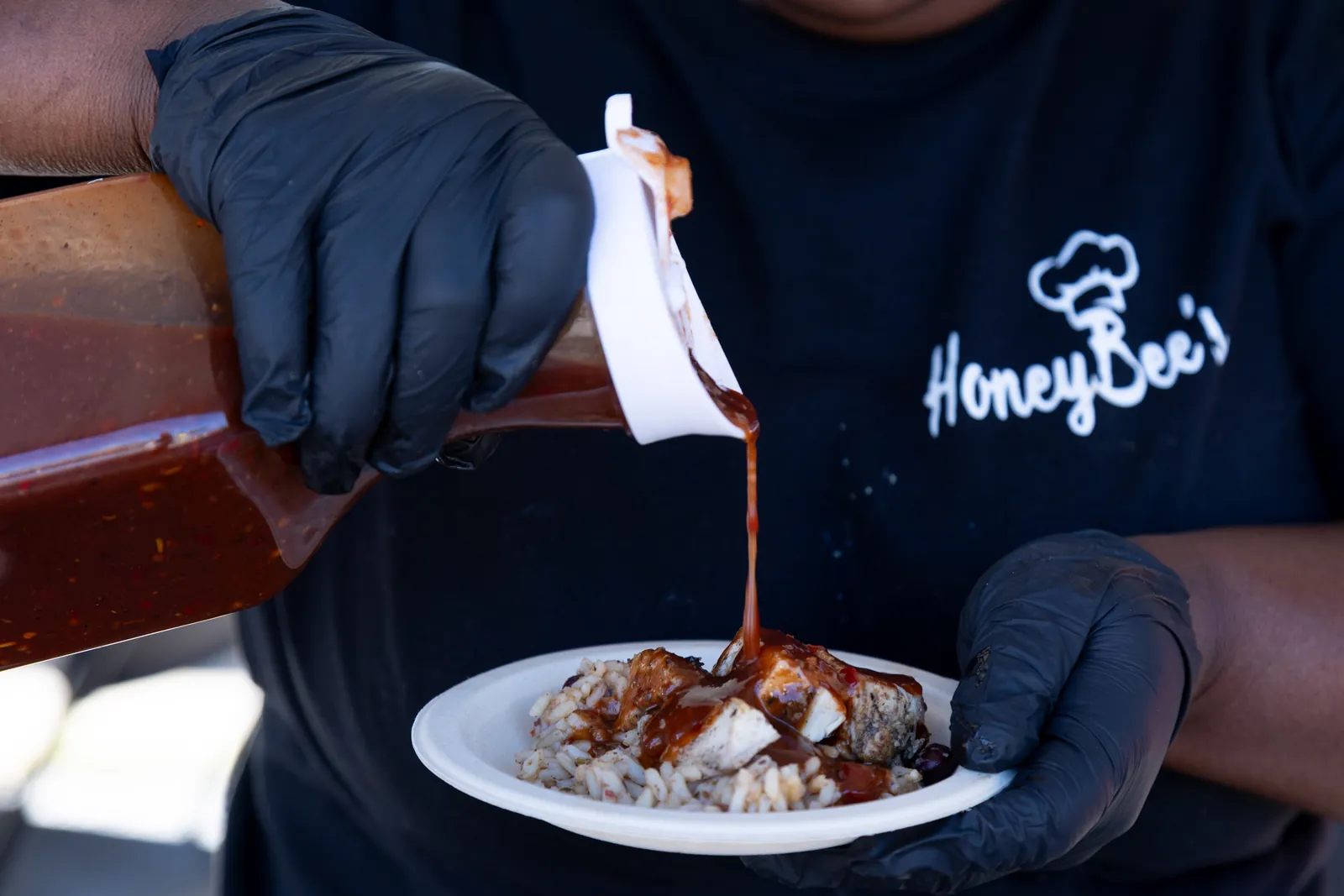 HoneyBee's Island Sauce poured over jerk chicken and rice