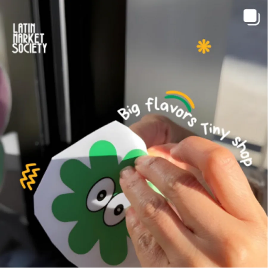 Peeling a Latin Market Society sticker — big flavors, tiny shop