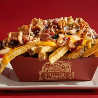 RedHead Burger loaded fries with cheese, bacon, and sauce in a branded container.