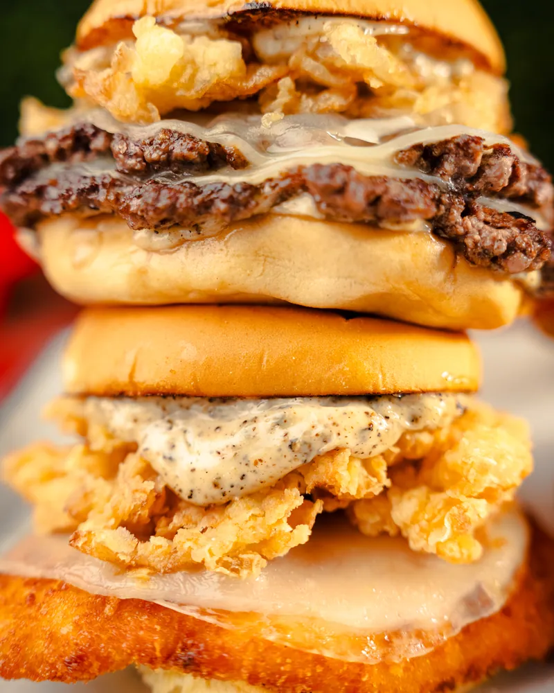 A stacked Redhead Burger cut open, the crust built into the patty
