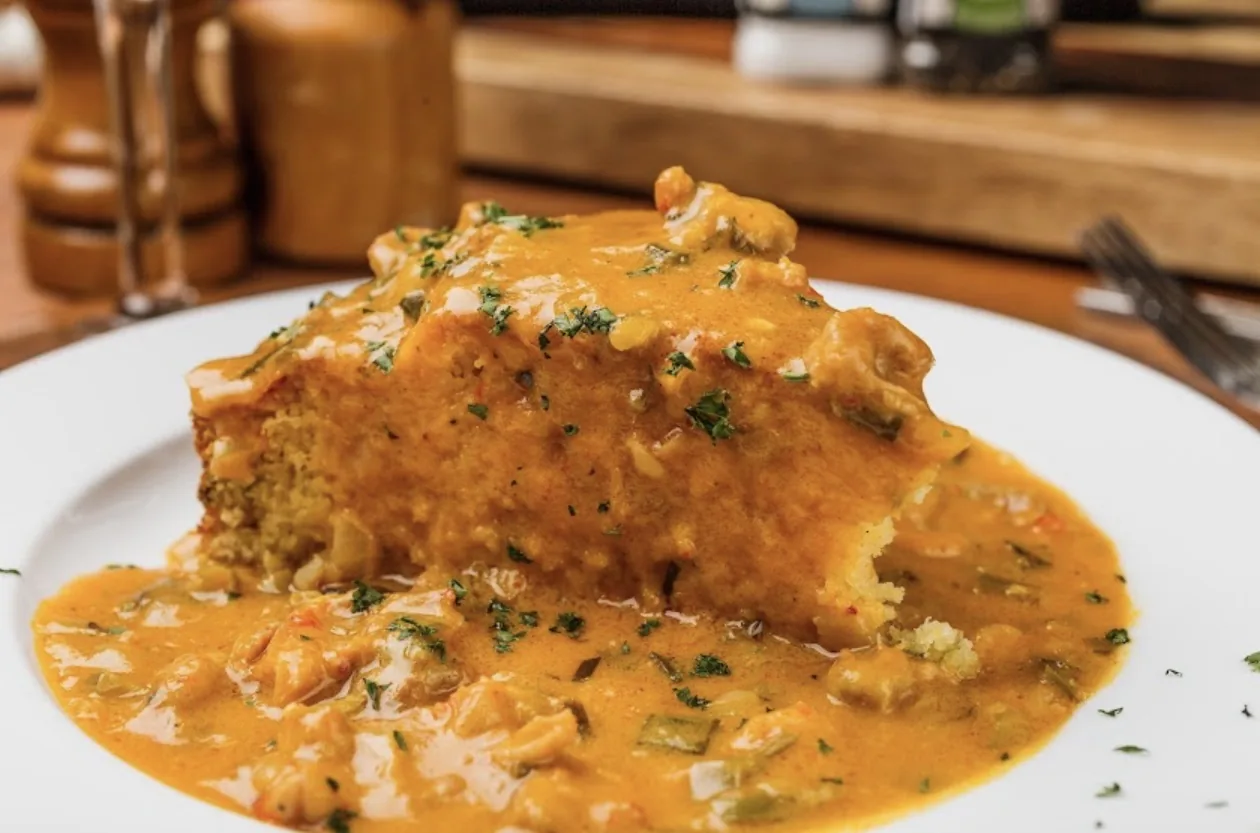 Crawfish etouffee ladled over the plate at Roberta’s Prime