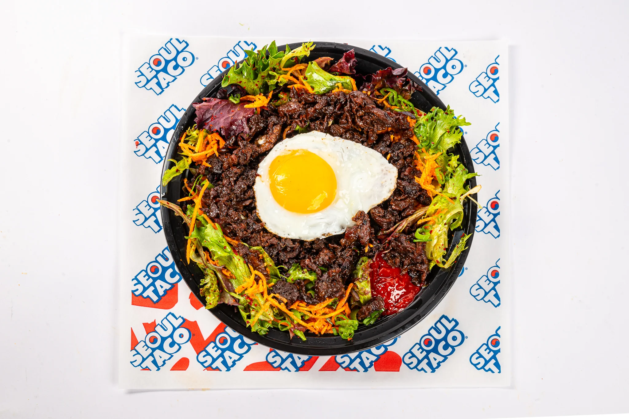 Gogi Bowl with bulgogi, salad, and sunny-side-up egg