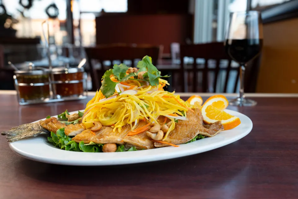 Mango trout topped with shredded mango and cashew nuts