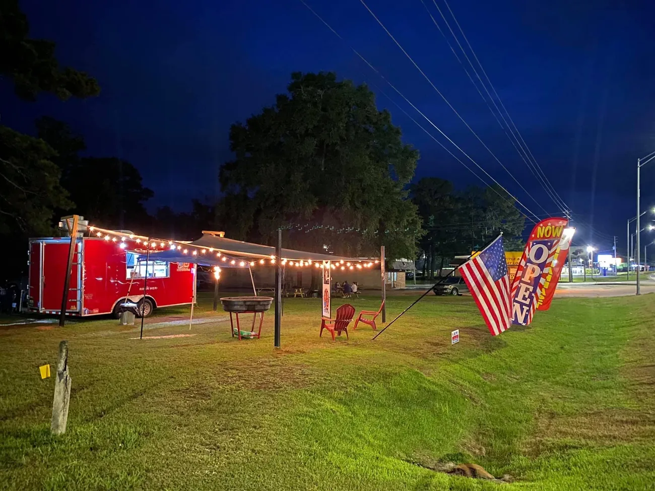 The Smash Mouth Foods trailer lit up with string lights at night