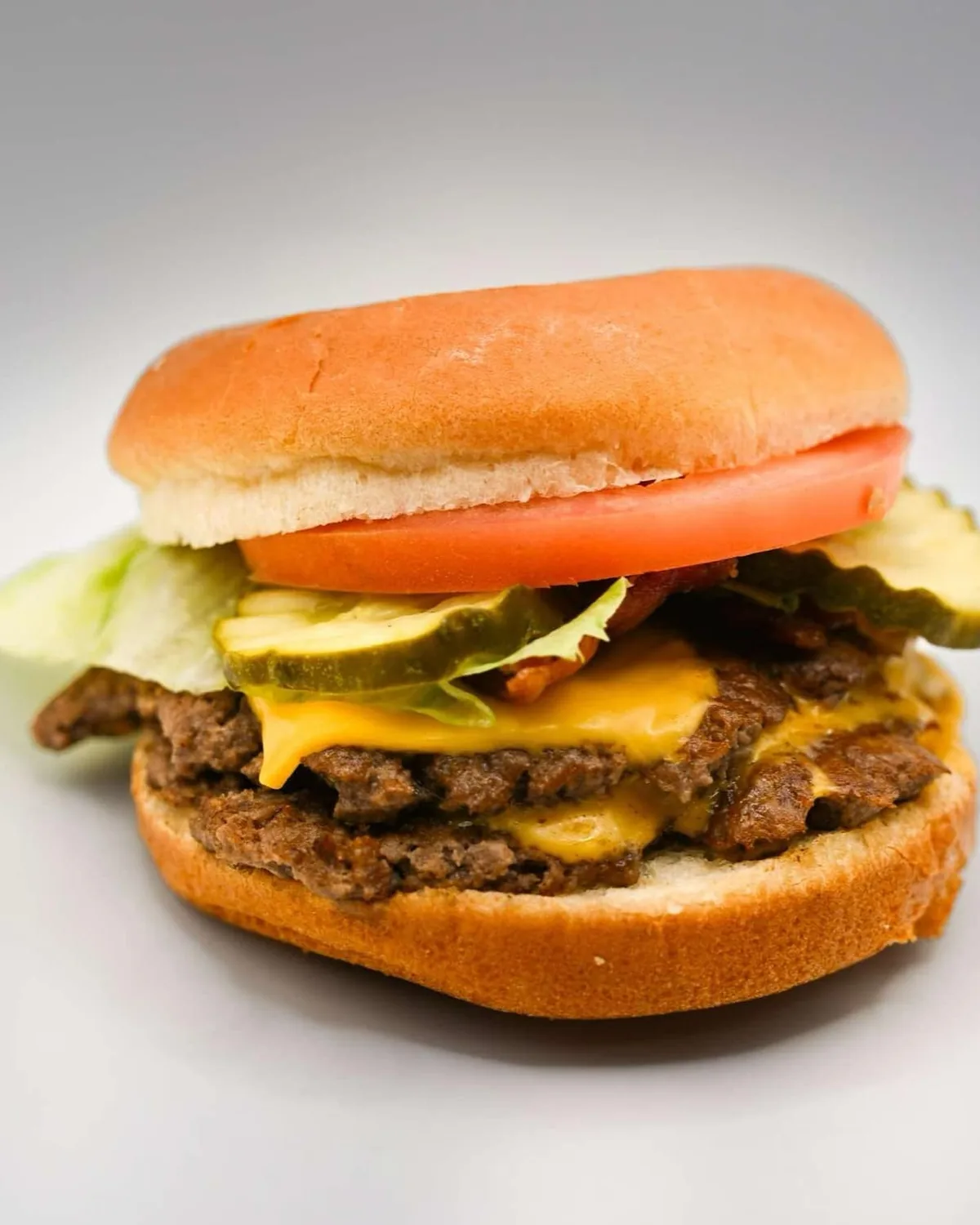 A Double Smash Burger with melted American cheese, lettuce, tomato and pickles