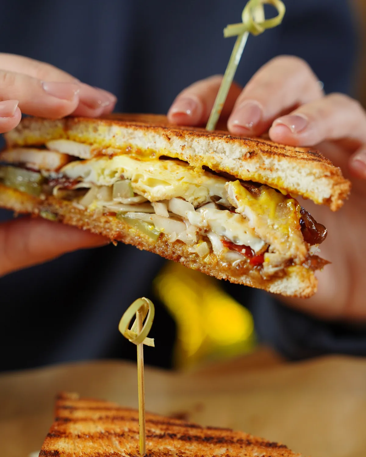 A Korean BBQ grilled chicken melt, cut and served