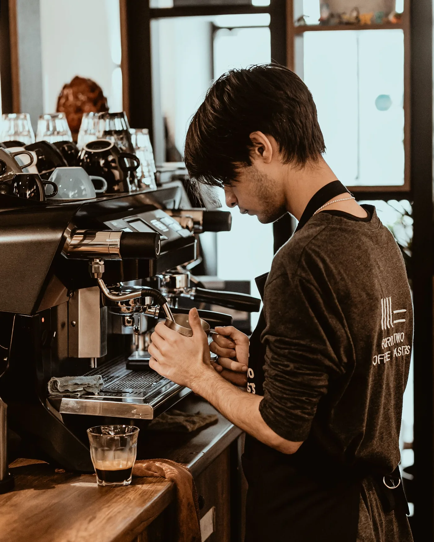 A barista at the group head