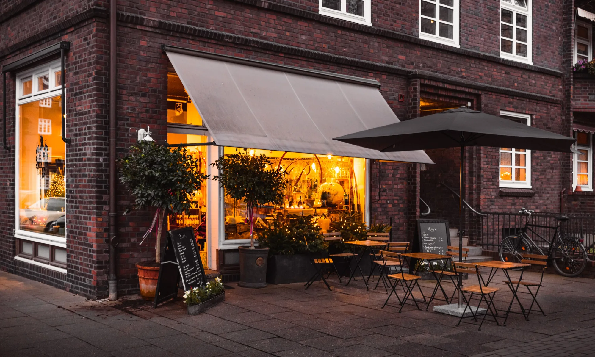 Warm light from the shopfront at dusk