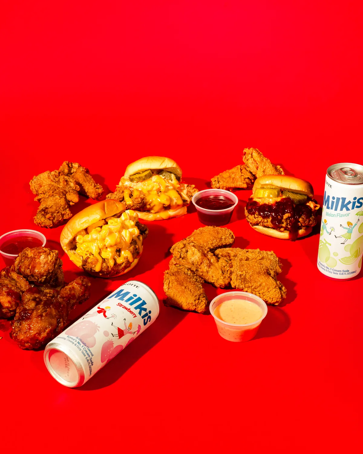 A full Ugly Chicken feast — wings, drummies, sandwiches, corn cheese and Milkis